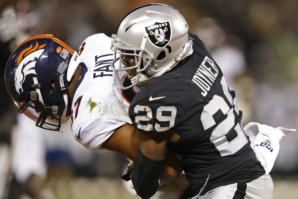 Denver Broncos tight end Noah Fant is stopped by Oakland Raiders free safety Lamarcus Joyner (2 ...
