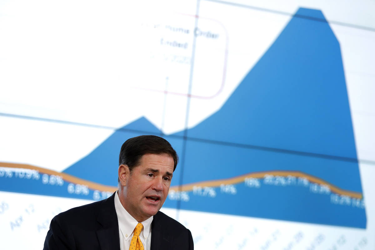 Arizona Republican Gov. Doug Ducey gives the latest Arizona coronavirus update during a news co ...