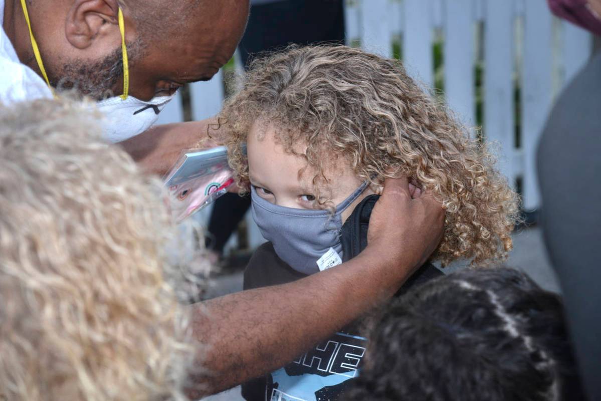 Michael Curtis gets help putting on his mask from his father Richard Curtis before entering Alc ...