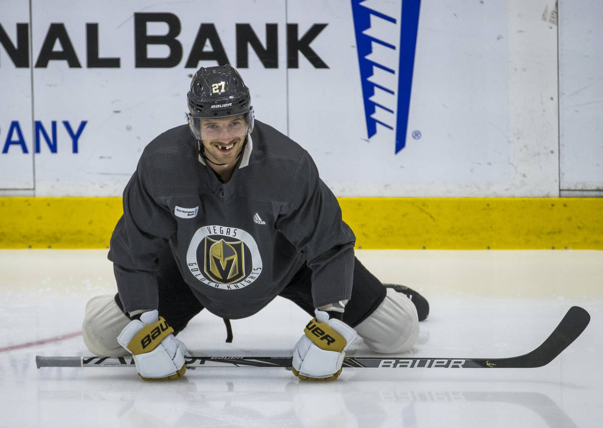 Vegas Golden Knights defenseman Shea Theodore (27) stretches on the ice during practice at the ...