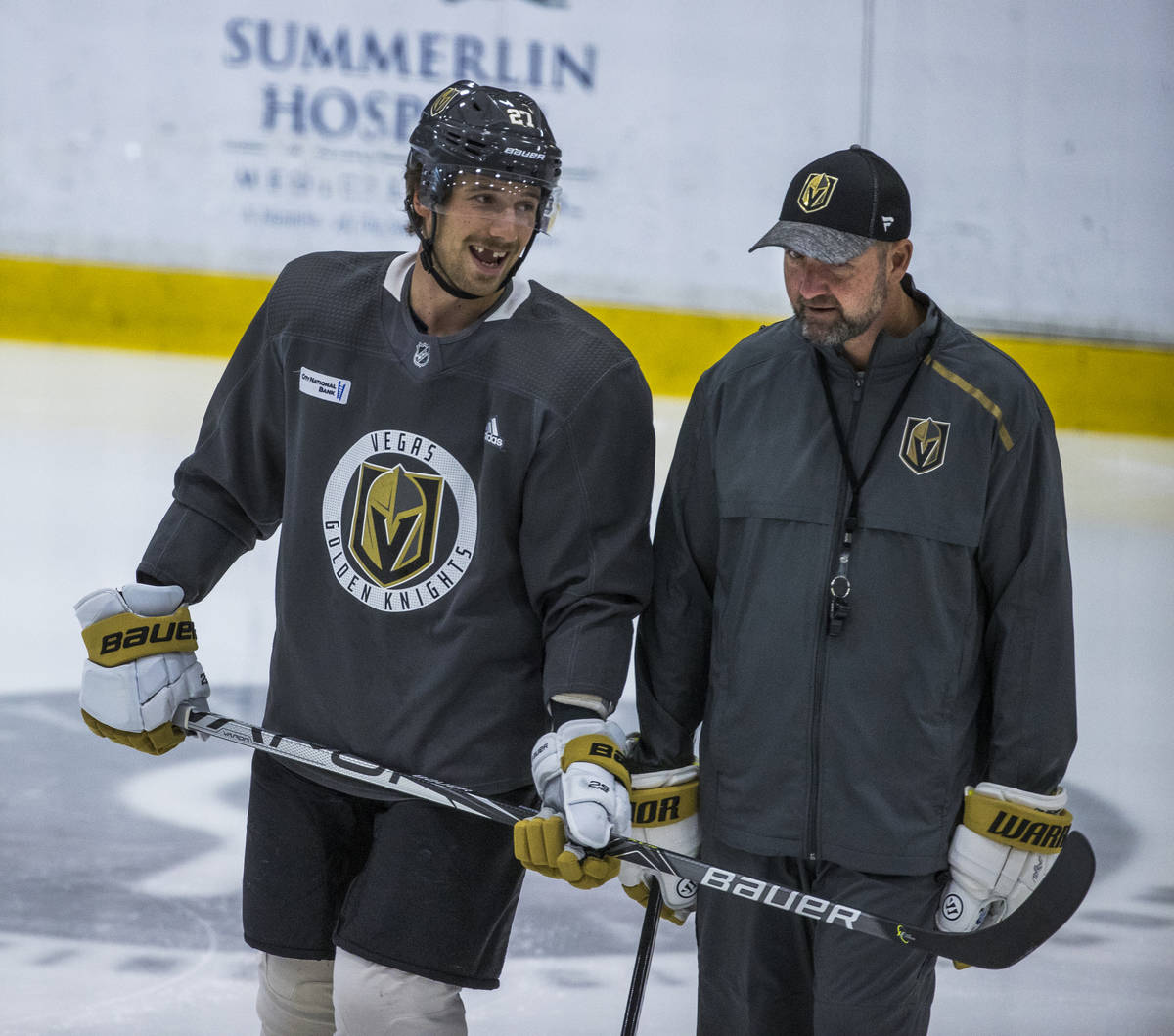 Vegas Golden Knights defenseman Shea Theodore (27) chats with head coach Peter DeBoer during pr ...