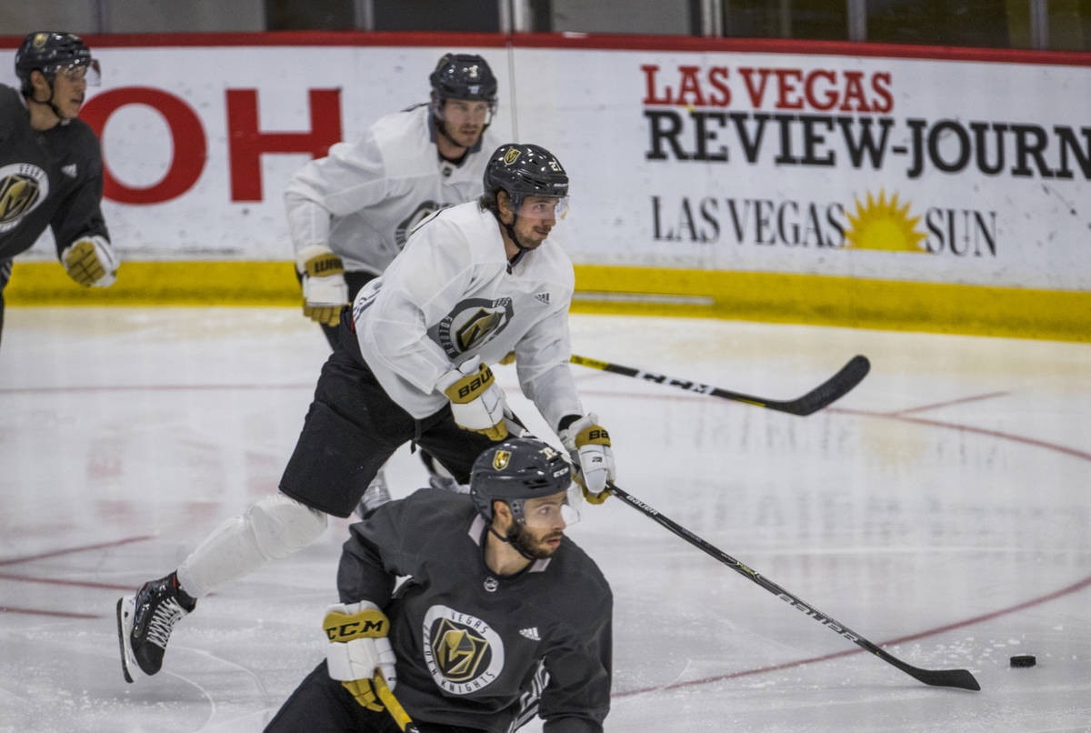 Vegas Golden Knights defenseman Shea Theodore (27, center) moves up the ice during practice at ...