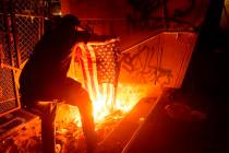 A Black Lives Matter protester burns an American flag outside the Mark O. Hatfield United State ...