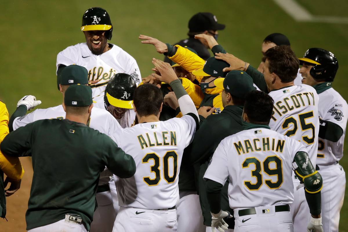 Oakland Athletics players celebrate after Matt Olson, center left, hit a grand slam home run ag ...