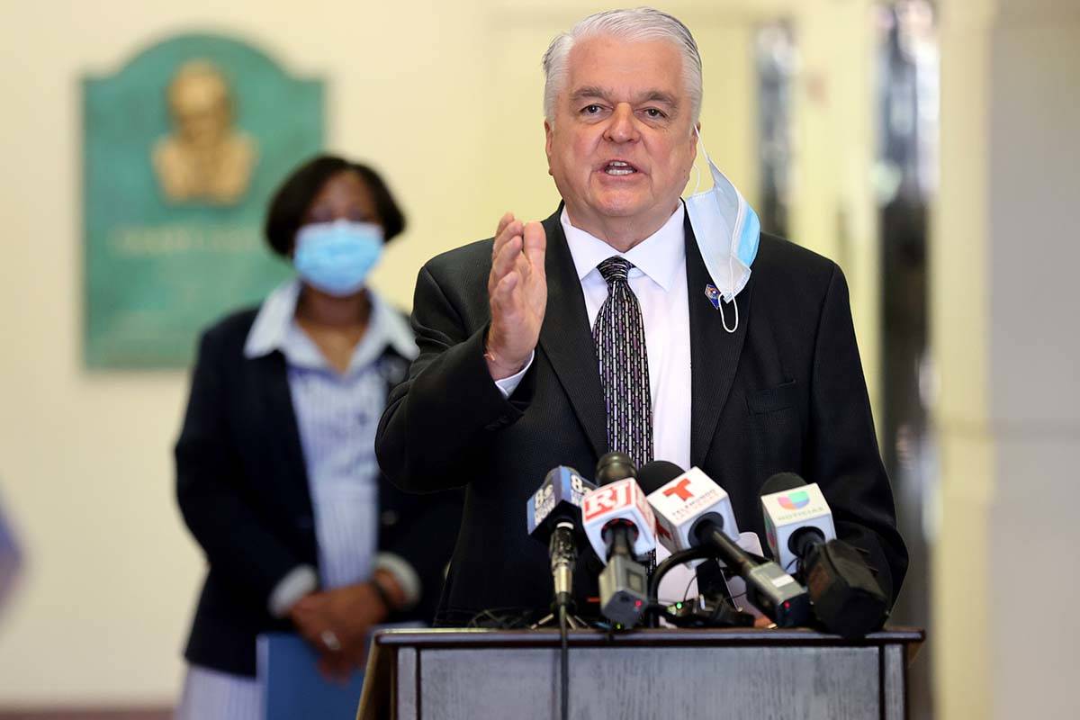 Gov. Steve Sisolak speaks as Assemblywoman Daniele Monroe-Moreno looks on during a news confere ...