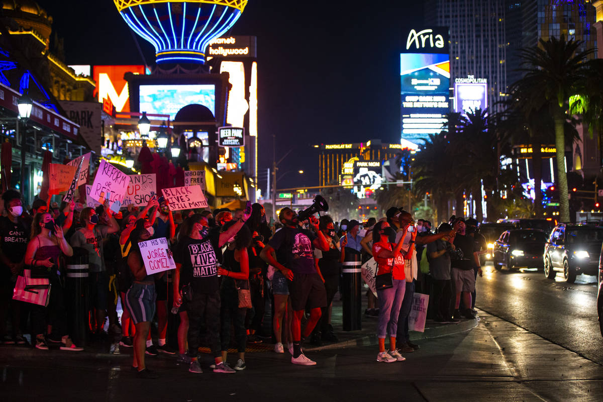 People record and chant after Las Vegas police stopped a car that was assisting Black Lives Mat ...