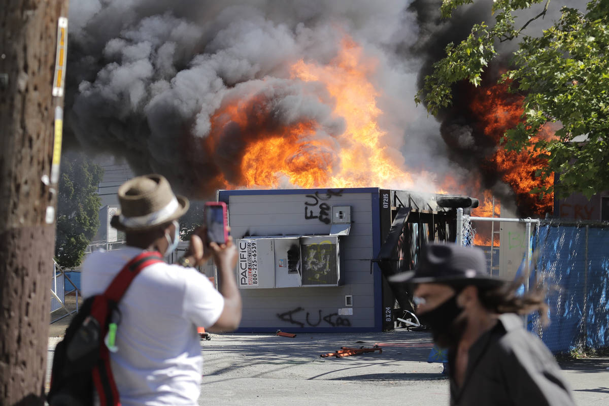 EDS NOTE: OBSCENITY - Construction buildings burn near the King County Juvenile Detention Cente ...