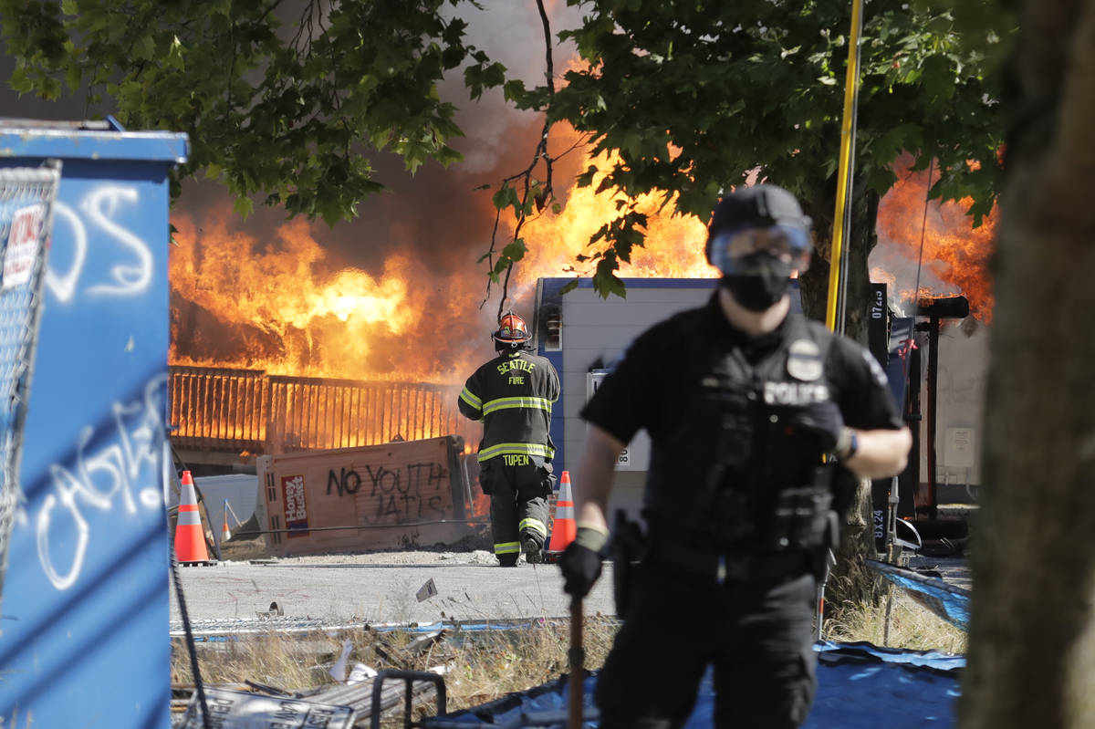 Construction buildings burn near the King County Juvenile Detention Center, Saturday, July 25, ...