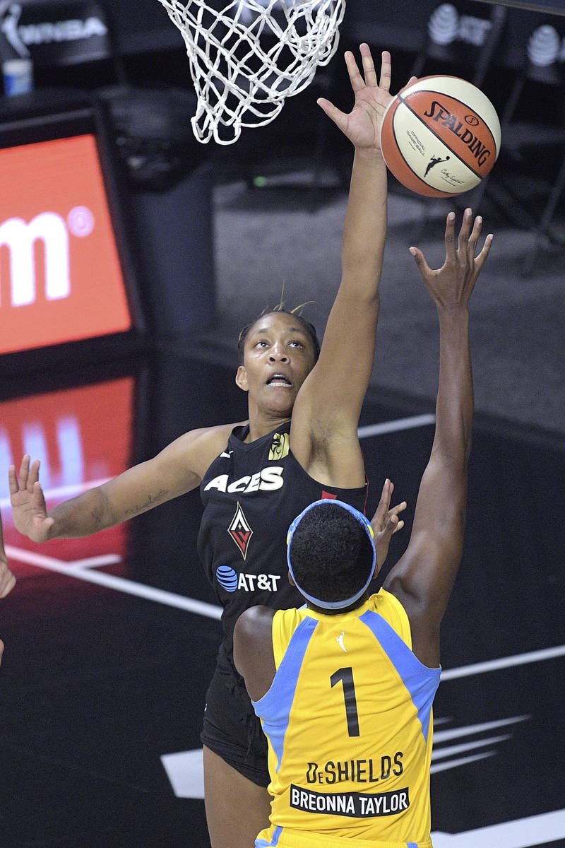 Las Vegas Aces forward A'ja Wilson, top, defends as Chicago Sky guard Diamond DeShields (1) goe ...