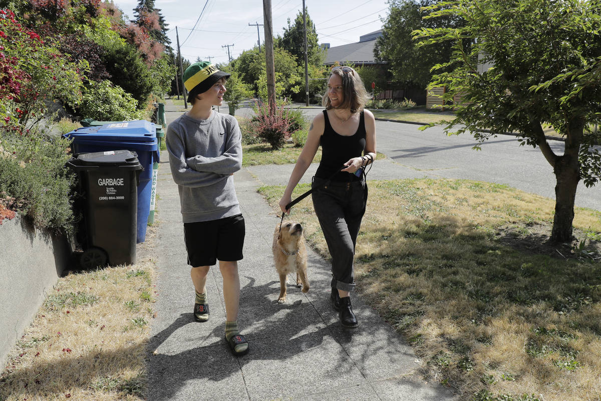 Jennifer Haller, right, the first person to receive a trial dose of a COVID-19 vaccine, walks w ...