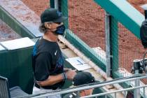 Miami Marlins' manager Don Mattingly looks out from the dugout during the eighth inning of a ba ...