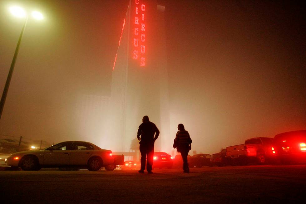 Dust from the Stardust Casino impolsion envelopes the Circus Circus as people walk back to thei ...