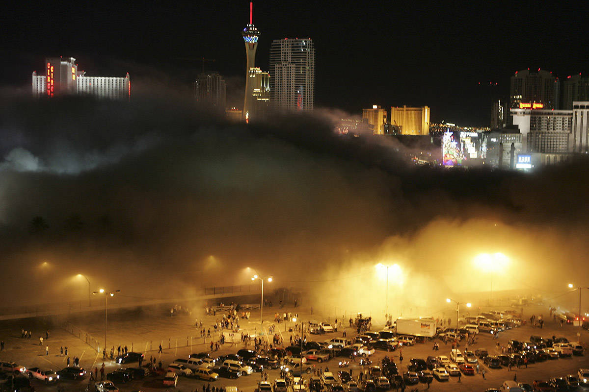 A cloud of dust from the Stardust hotel-casino rolls over spectators and media in the Frontier ...