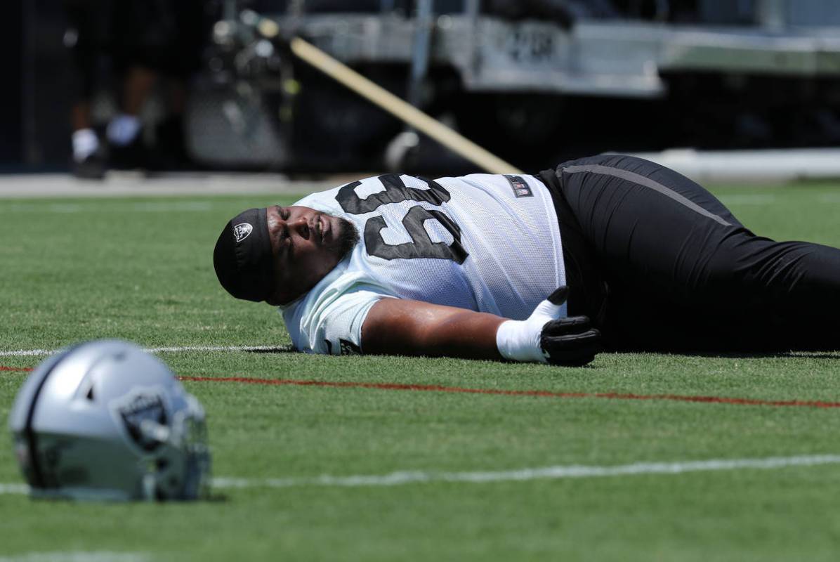 Oakland Raiders offensive guard Gabe Jackson (66) stretches during a mandatory mini-camp workou ...