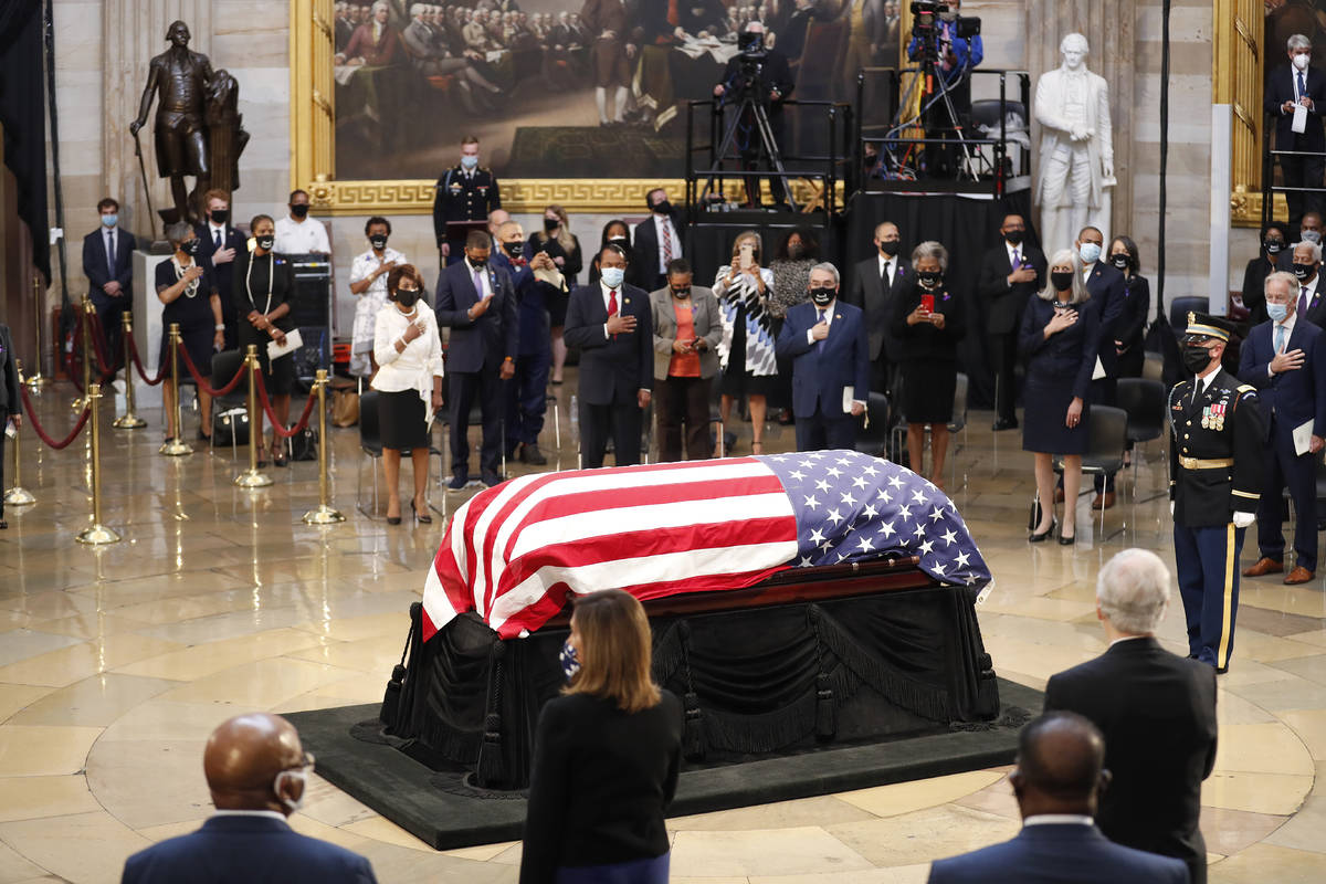 House Speaker Nancy Pelosi of Calif., second from left, attends a memorial service as the flag- ...