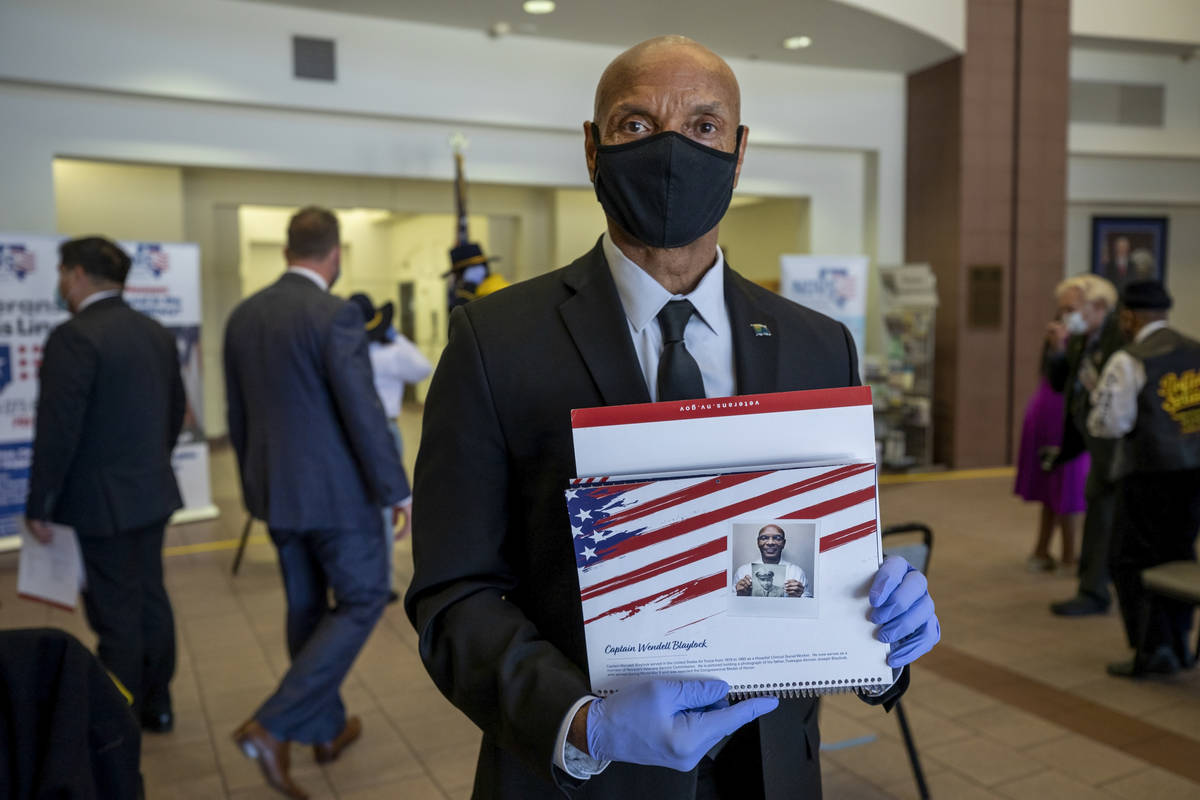 Capt. Wendell Blaylock holds a calendar page dedicated to his service in the U.S. Air Force, pr ...