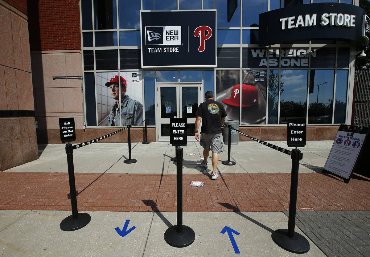 A person walks toward the Philadelphia Phillies team store at
