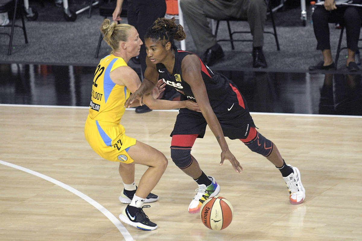 Las Vegas Aces guard Angel McCoughtry, right, drives to the lane in front of Chicago Sky guard ...