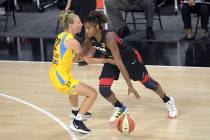 Las Vegas Aces guard Angel McCoughtry, right, drives to the lane in front of Chicago Sky guard ...