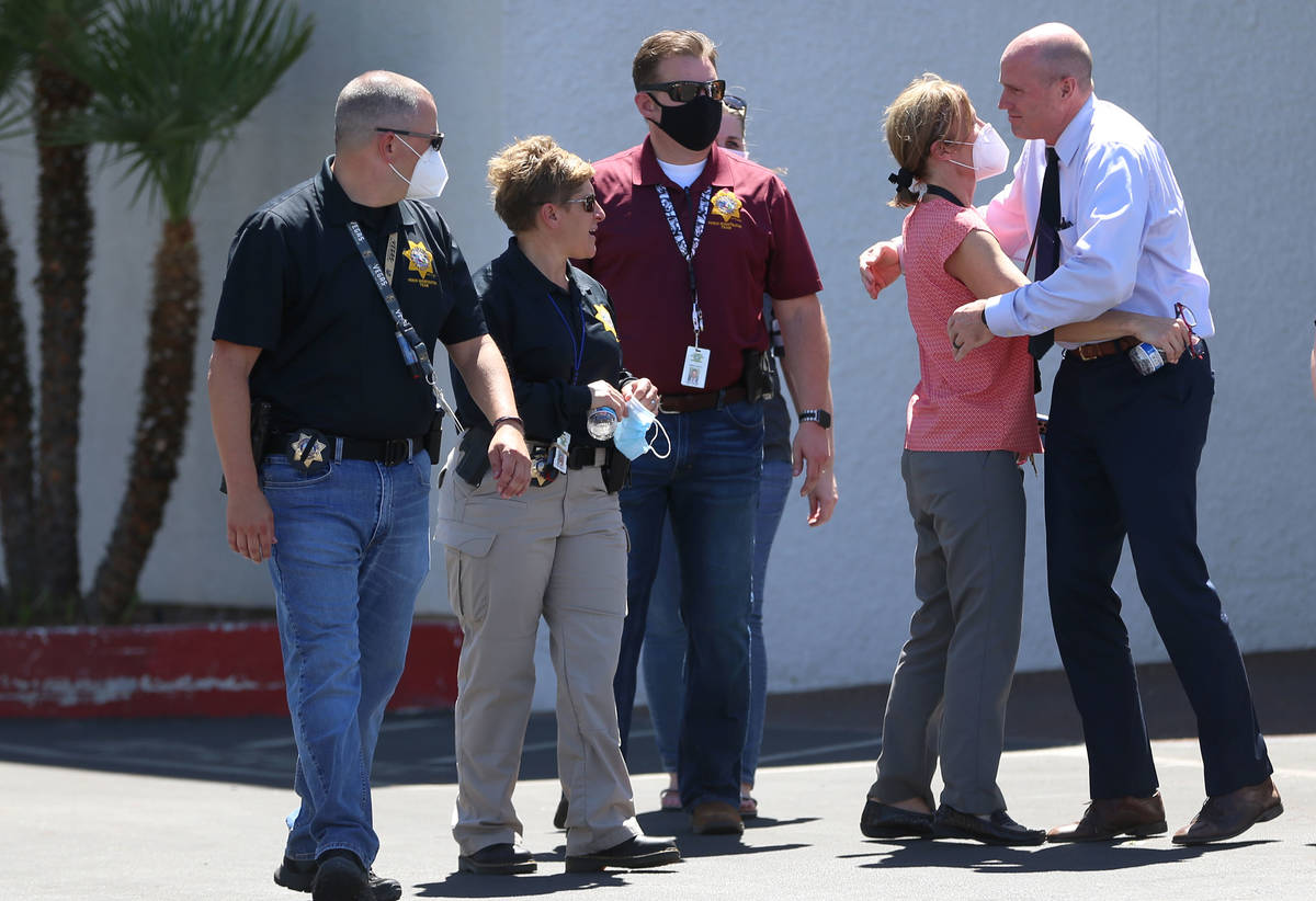 People including members of the Las Vegas Metropolitan Police Department outside of the Palm Do ...