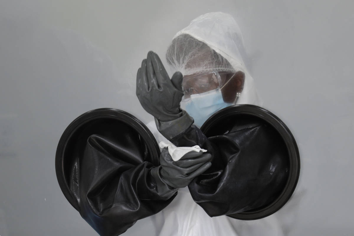 FILE - In this July 17, 2020, file photo, a health care worker sanitizes her equipment while wo ...