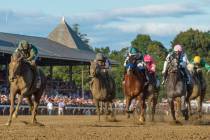 Code of Honor, left, with jockey John Velazquez, leads the field to the finish line to win the ...