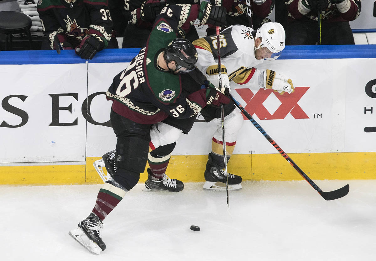 Arizona Coyotes' Christian Fischer (36) checks Vegas Golden Knights' Paul Stastny (26) during t ...