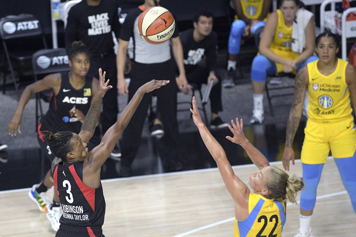 Las Vegas Aces guard Danielle Robinson (3) goes up to shoot in front of Chicago Sky guard Court ...