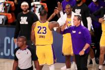 Los Angeles Lakers' LeBron James (23) celebrates with coach Frank Vogel after the Lakers defeat ...