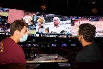 Dylan Speckman, left, and John Lewos, both of Jacksonville Beach, Fla., watch the Vegas Golden ...