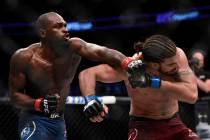 Derek Brunson, left, punches Elias Theodorou during a middleweight mixed martial arts bout duri ...
