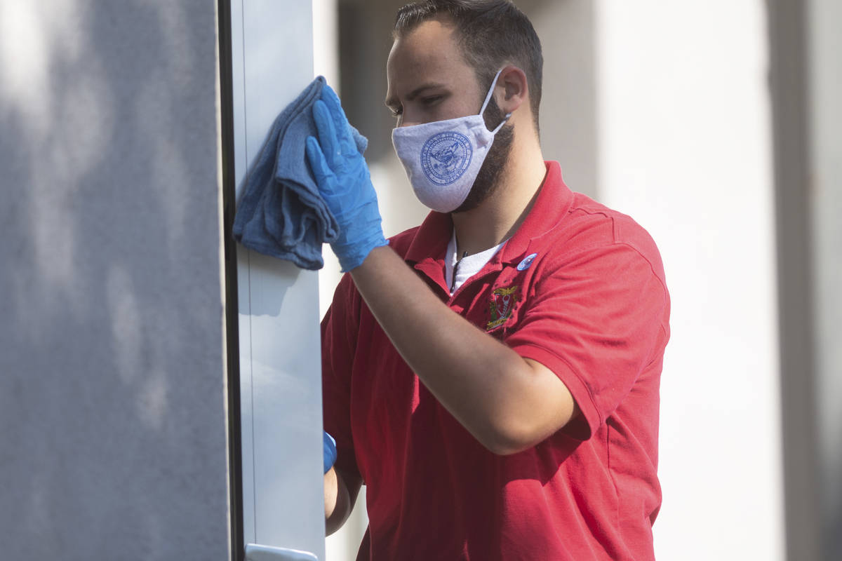 A member of the legislative janitorial crew cleans on Friday, July 31, 2020 during the first da ...