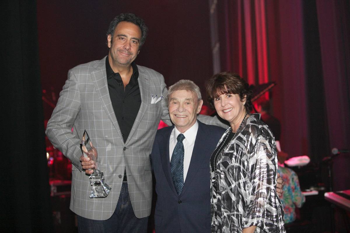 Comedian Brad Garrett, left, with Las Vegas real estate developer Irwin Molasky and Carole Fish ...