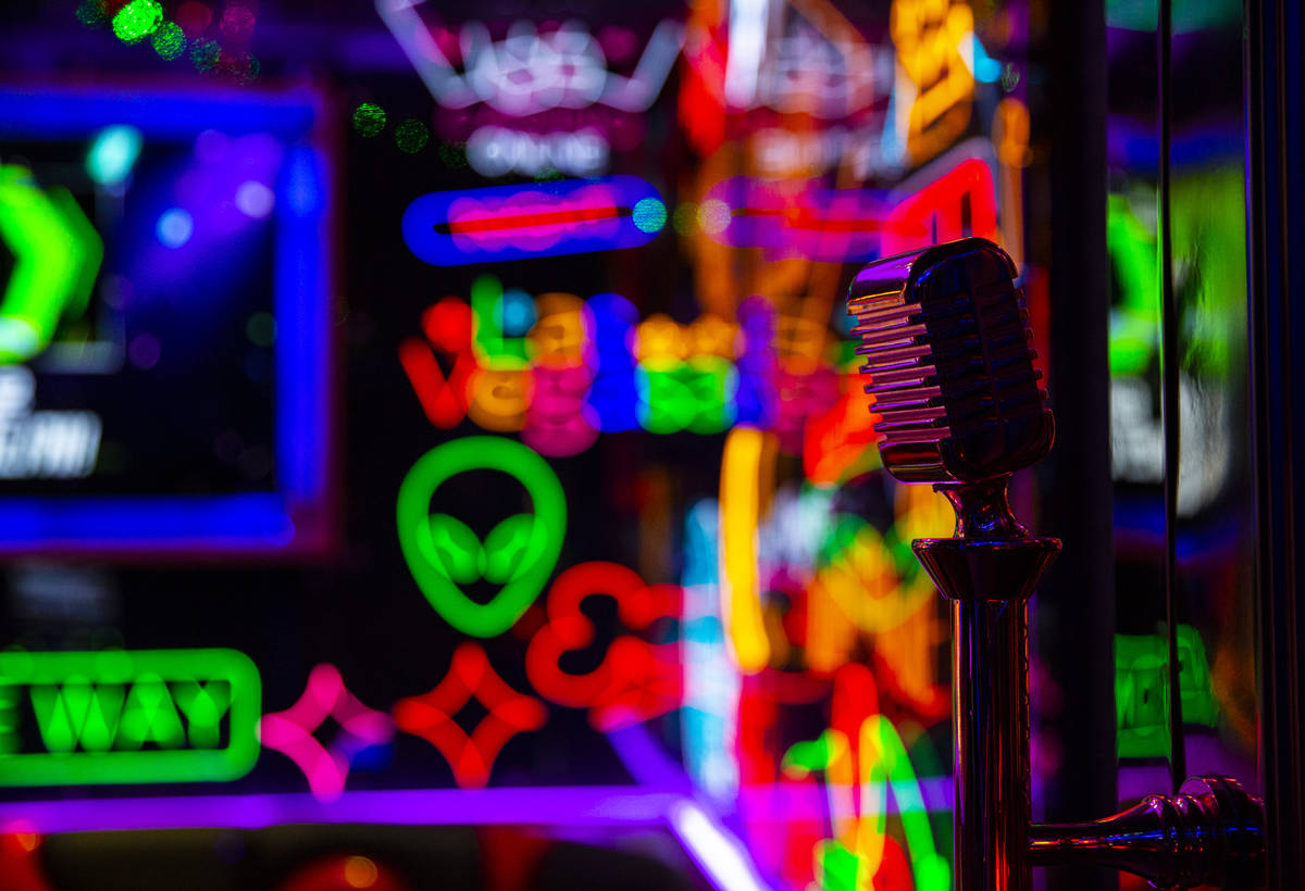 A door handle featuring a microphone in a room filled with neon at Kamu Karaoke at the Grand Ca ...