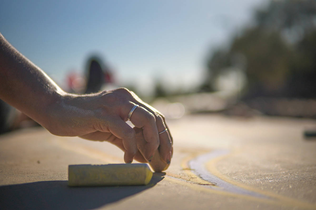 Nicole Cox works on a public chalk drawing on Friday, July 3, 2020, at Nevada Trails Park in La ...