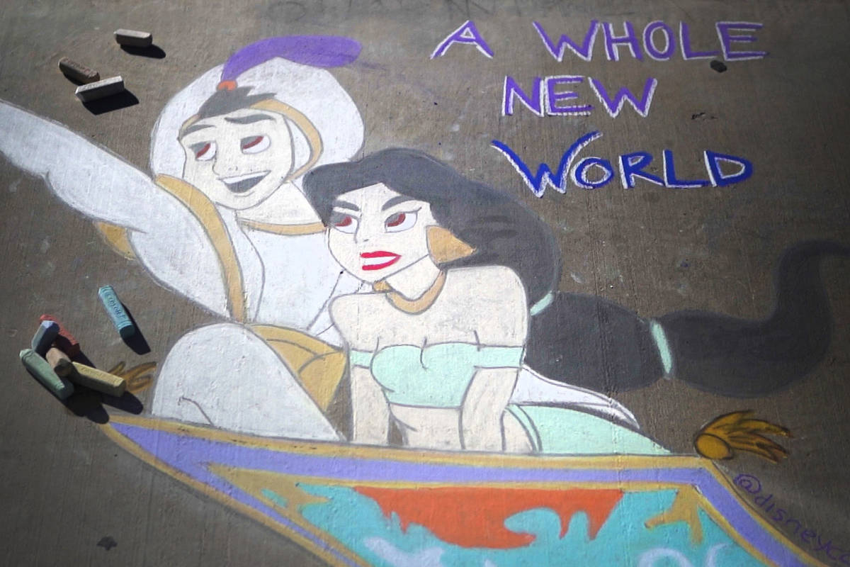 A public chalk drawing by Nicole Cox, of Las Vegas, called “A Whole New World” features Dis ...