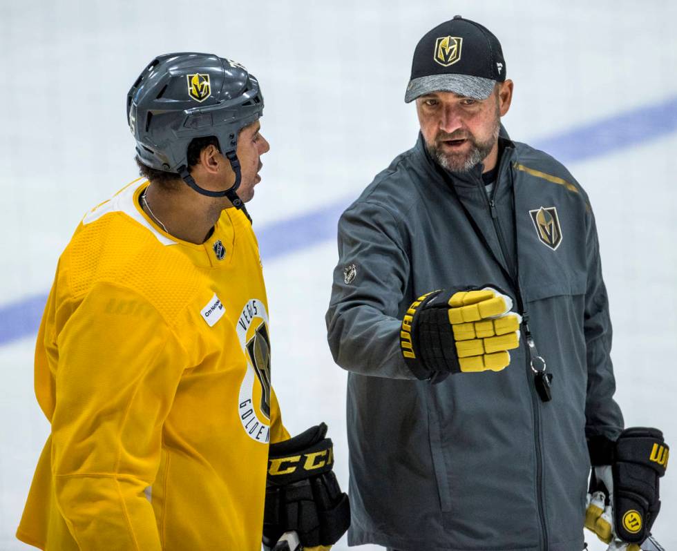 Vegas Golden Knights right wing Ryan Reaves (75, left) listens on the ice to head coach Peter D ...