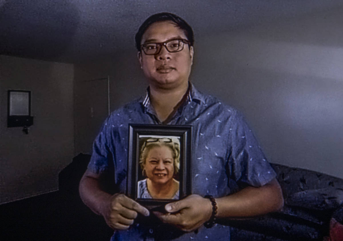 Roderick Alimusa holds a photograph of his mother, Maria Alimusa, who died at the Heights of Su ...
