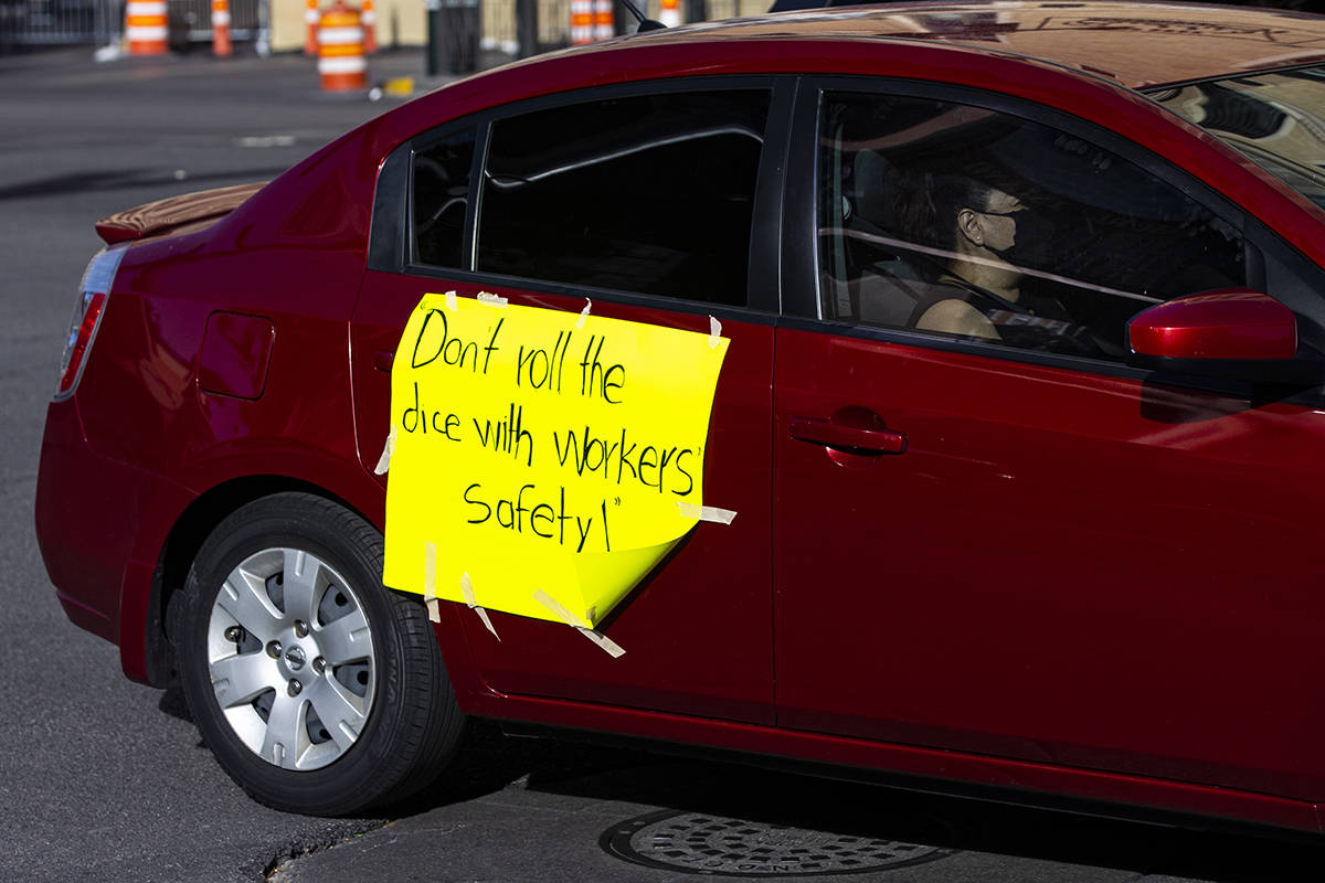 People participate in a car caravan on the Las Vegas Strip led by the Culinary Union on Tuesday ...
