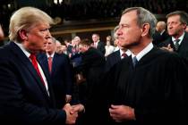 President Donald Trump greets Supreme Court Chief Justice John Roberts as he arrives to deliver ...