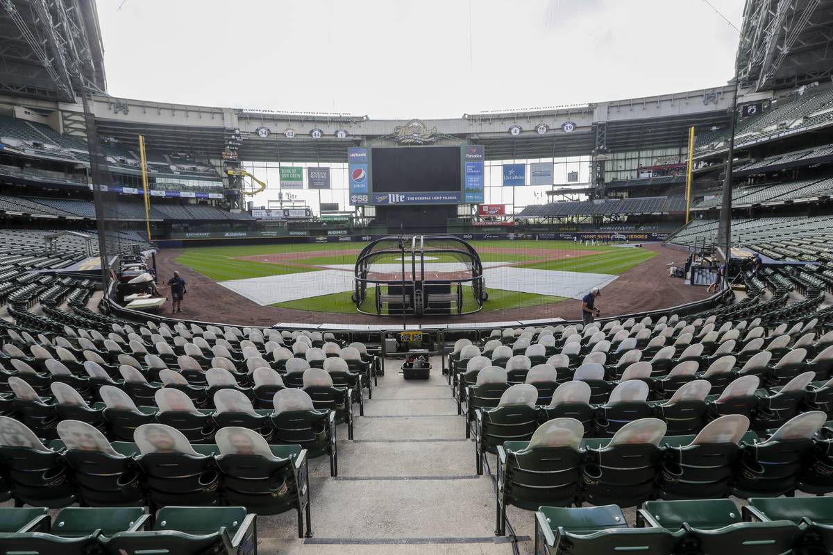 FILE - In this Friday, July 31, 2020, file photo, fan cutouts sit in seats behind home plate at ...