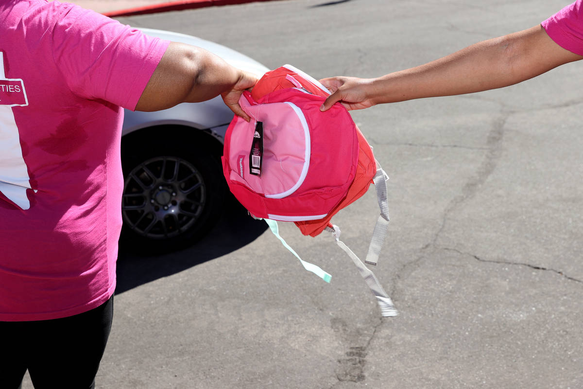 A backpack is given away during an event hosted by Clark County Commission Vice Chairman Lawren ...