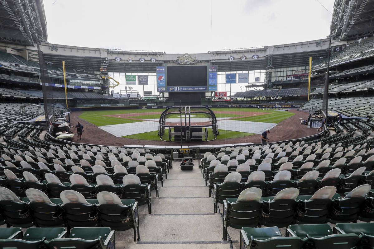 FILE - In this Friday, July 31, 2020, file photo, fan cutouts sit in seats behind home plate at ...