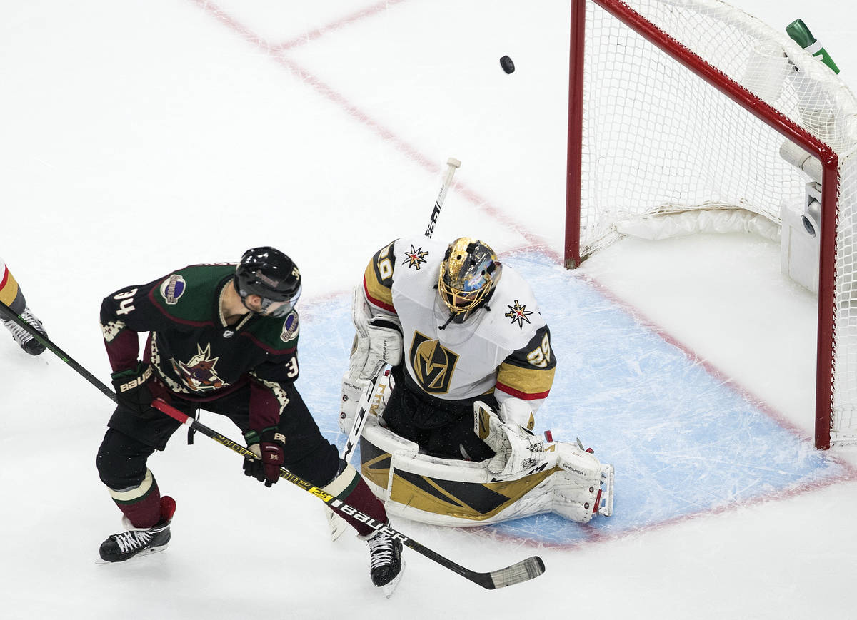 Arizona Coyotes' Carl Soderberg (34) is stopped by Vegas Golden Knights goalie Marc-Andre Fleur ...
