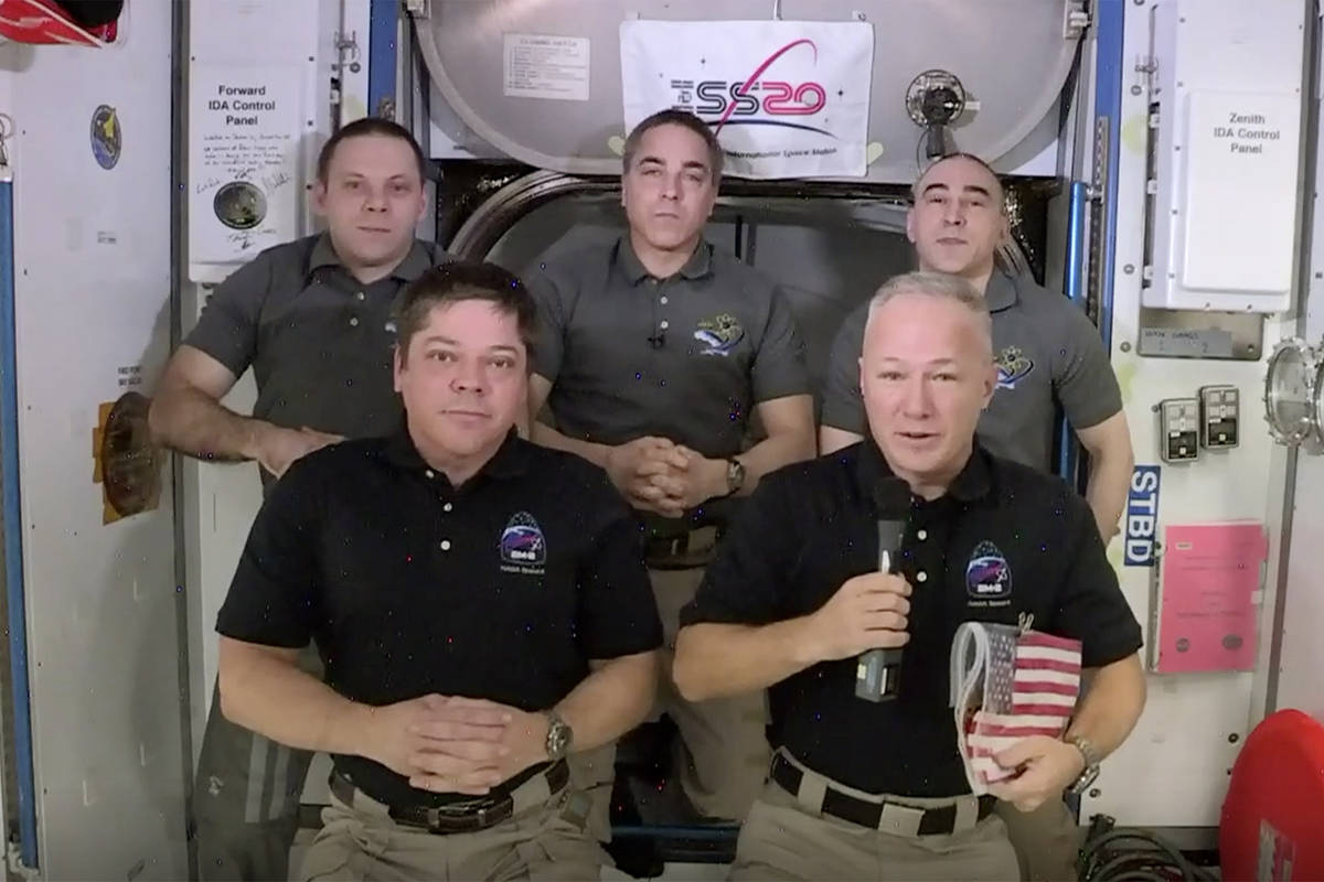 This photo provided by NASA shows, from left, front, astronauts Bob Behnken and Doug Hurley dur ...