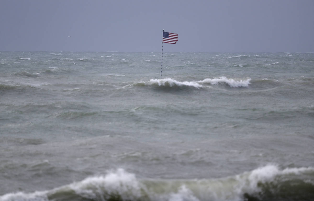 An American flag flies from the shipwreck of the Breconshire, as waves churned up by Tropical S ...