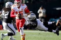 Kansas City Chiefs quarterback Patrick Mahomes (15) sheds tackle by Oakland Raiders defensive e ...