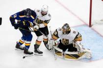 St. Louis Blues' Zach Sanford (12) and Vegas Golden Knights' Shea Theodore (27) battle in front ...