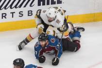 Colorado Avalanche's J.T. Compher (37) is checked by Vegas Golden Knights' Alex Tuch (89) durin ...