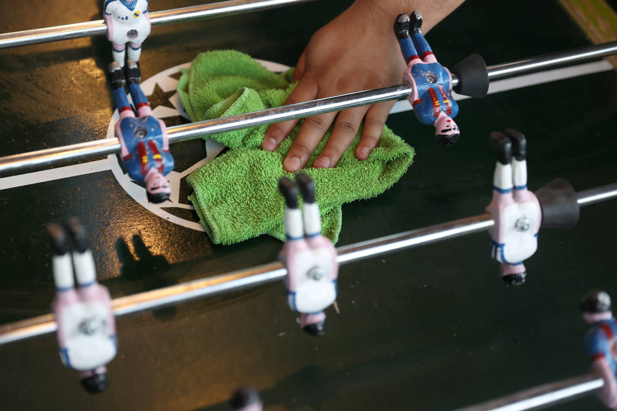 Shop owner Luis Arturo Cordoba Reyes cleans his foosball tables at Broadacres Marketplace in No ...